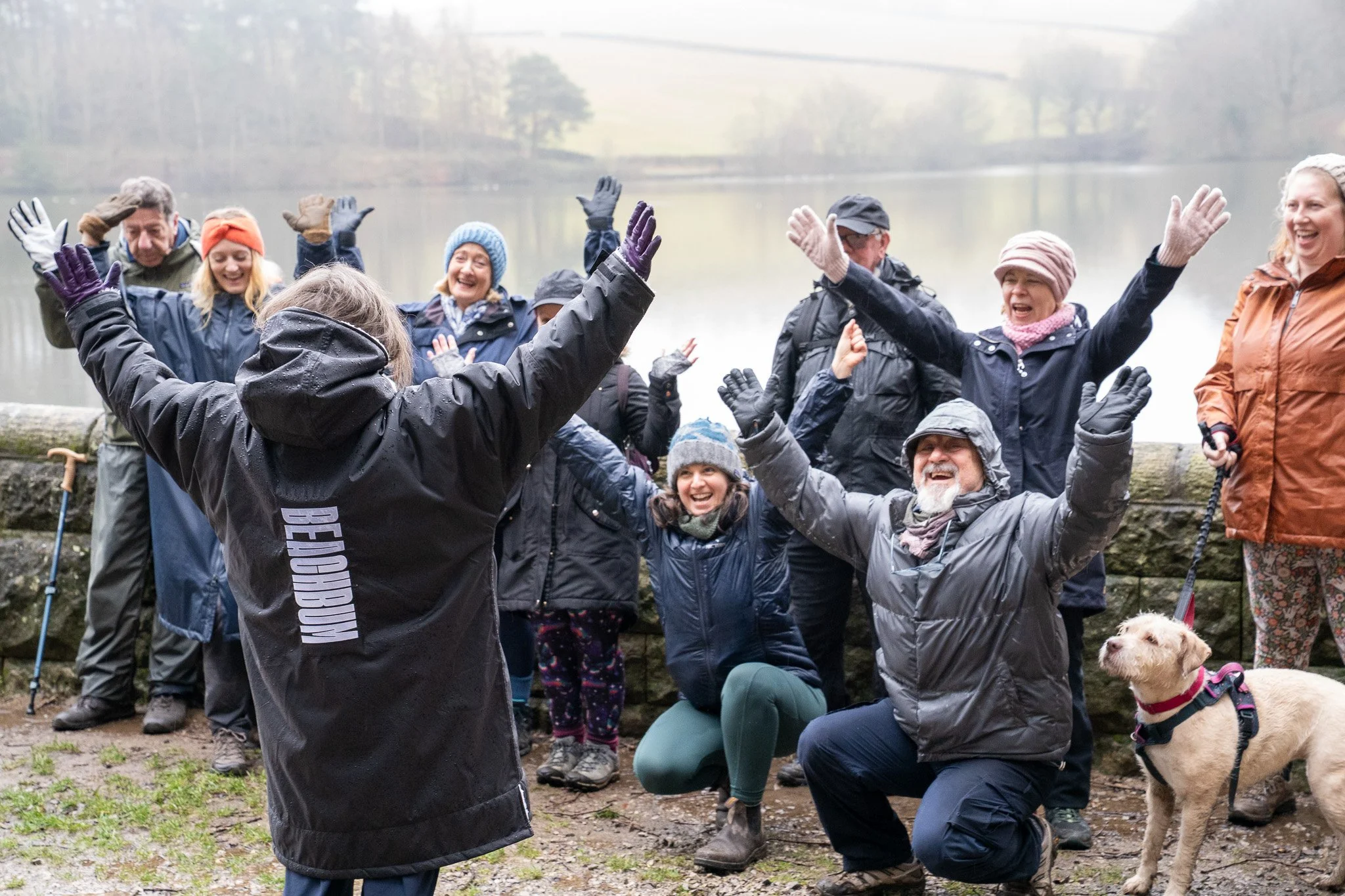 A group of people on Folc's first Ramble event in Chesterfield. Their arms are raised and they're cheering.