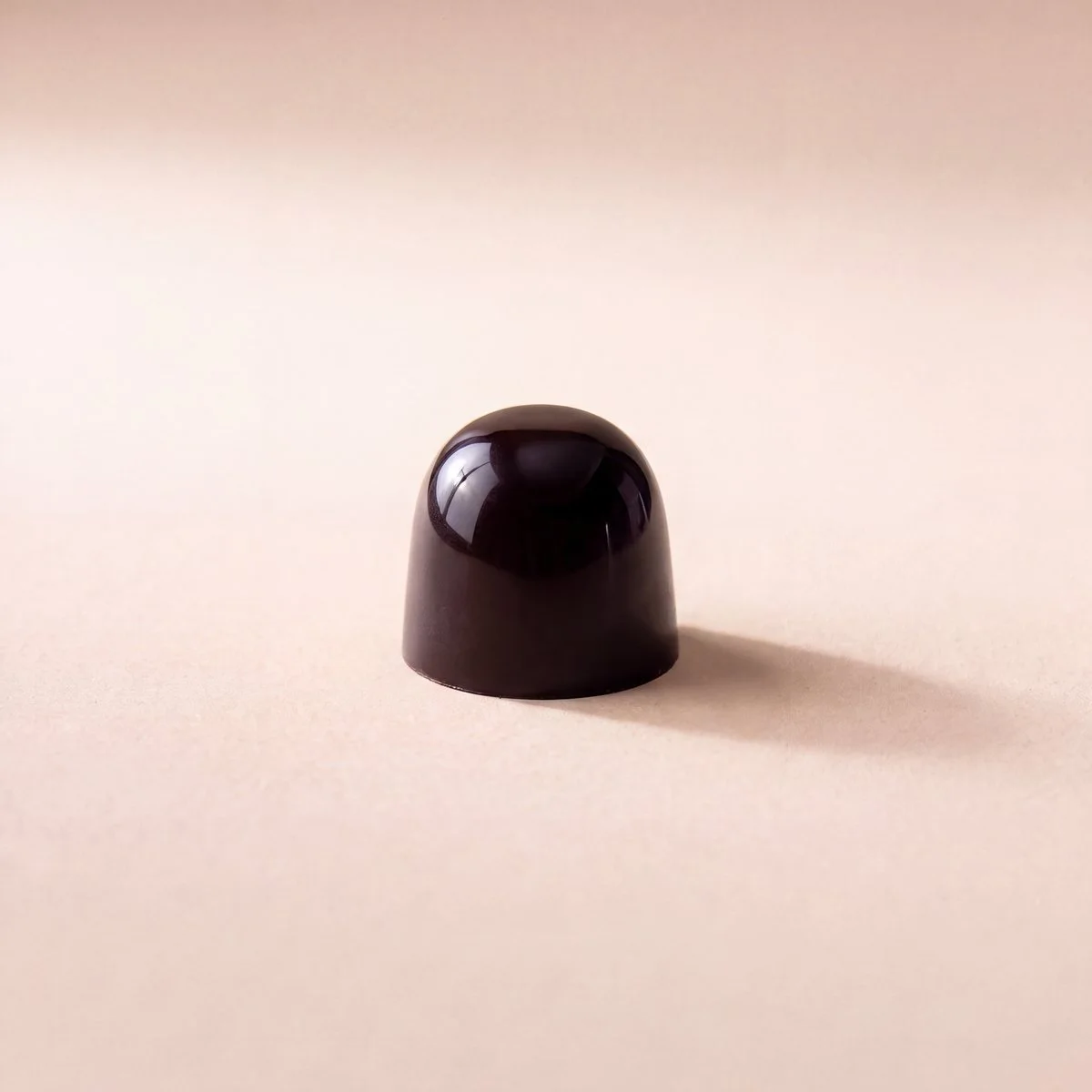 Espresso bonbon, glossy dark chocolate shell
