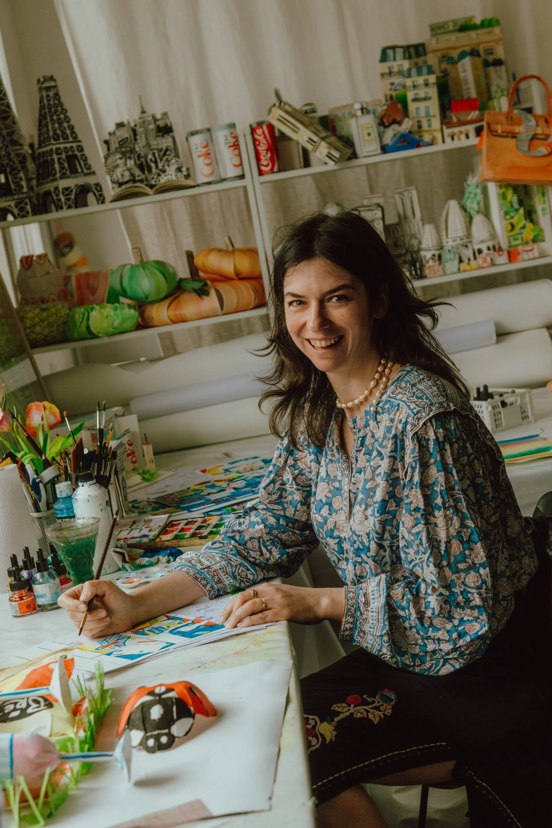Watercolor artist in whimsical watercolor studio