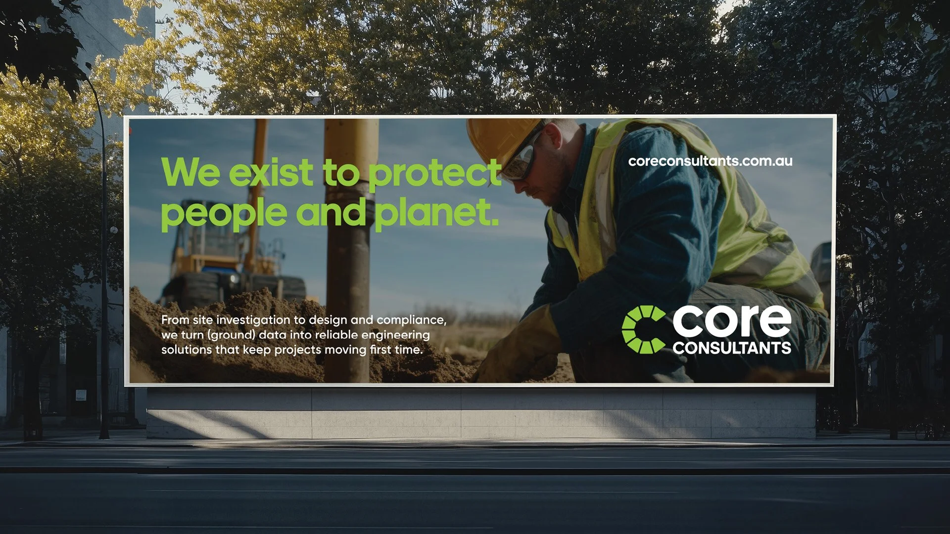 Billboard promoting Core Consultants with a construction worker in the background, applying soil or ground. Text states, "We exist to protect people and planet." and additional information about engineering solutions.