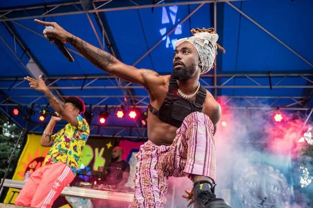 Earth Gang performing on a secondary Oasis Stage (First time that stage appeared at UMS, a makeshift car garage turned into a vivid day stage)