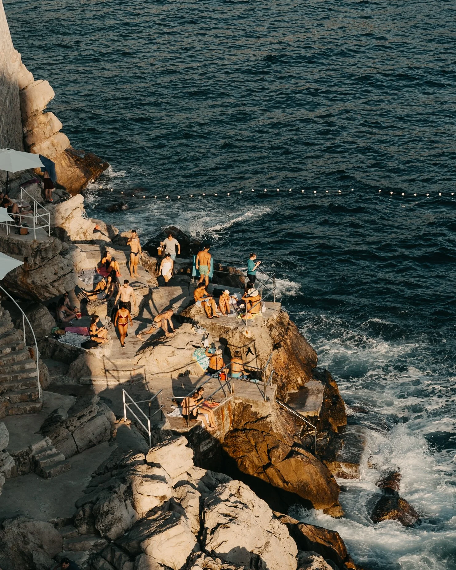 Soaking up the sun on the Dubrovnik wall beach at sunset golden hour 