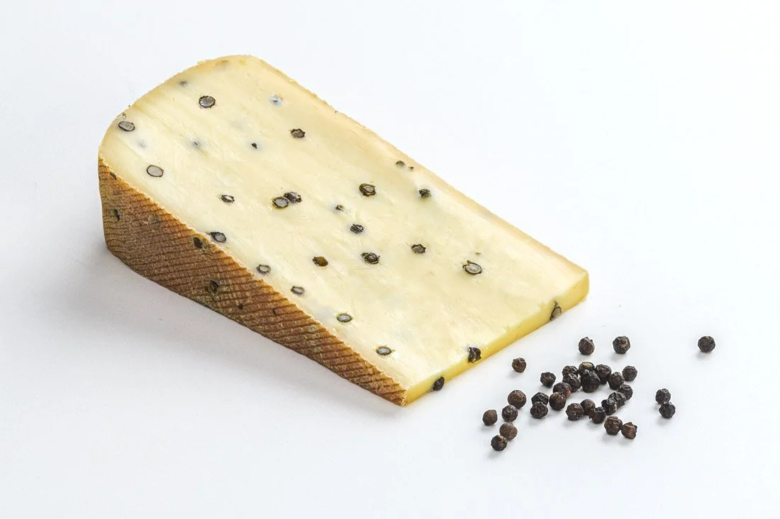 Heumilch Pfefferkäse (Schnittkäse) aus der Käsestraße Bregenzerwald in Vorarlberg. Geschmack: mild, aromatisch mit Pfefferkörner im Käseteig. Jetzt online kaufen in Ferdl's Käse online Shop.