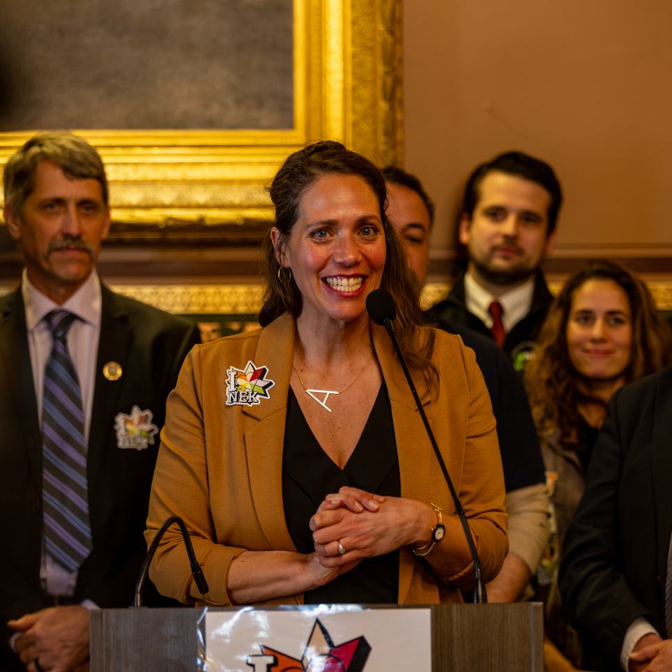 woman smiling behind a podium