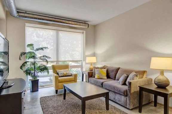 A nicely furnished apartment living room. 