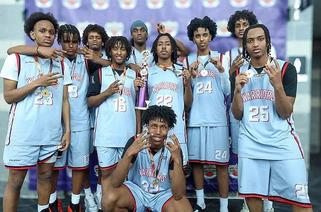 A teenage basketball team wearing silver medals and posing for the camera.