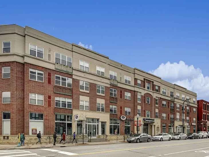 The exterior of a brown brick apartment building. 