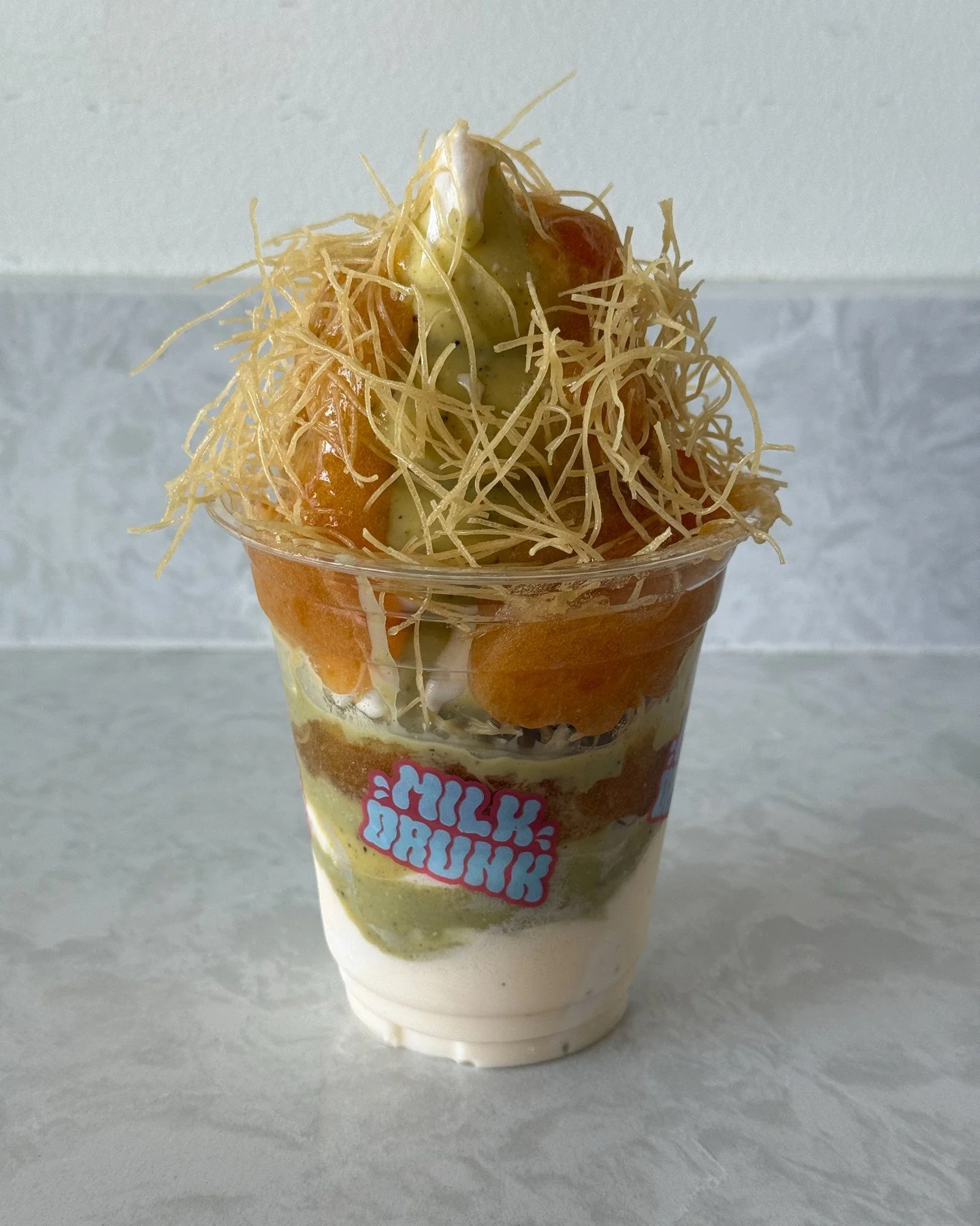 Check out the Sunday Sundae for May! This month, we are dishing out the Apricot Chai Sundae! Dig into layers of masala chai and apricot lassi soft serve, pistachio hard shell, apricot jam, and kataifi. This delicious treat is only available on Sunday
