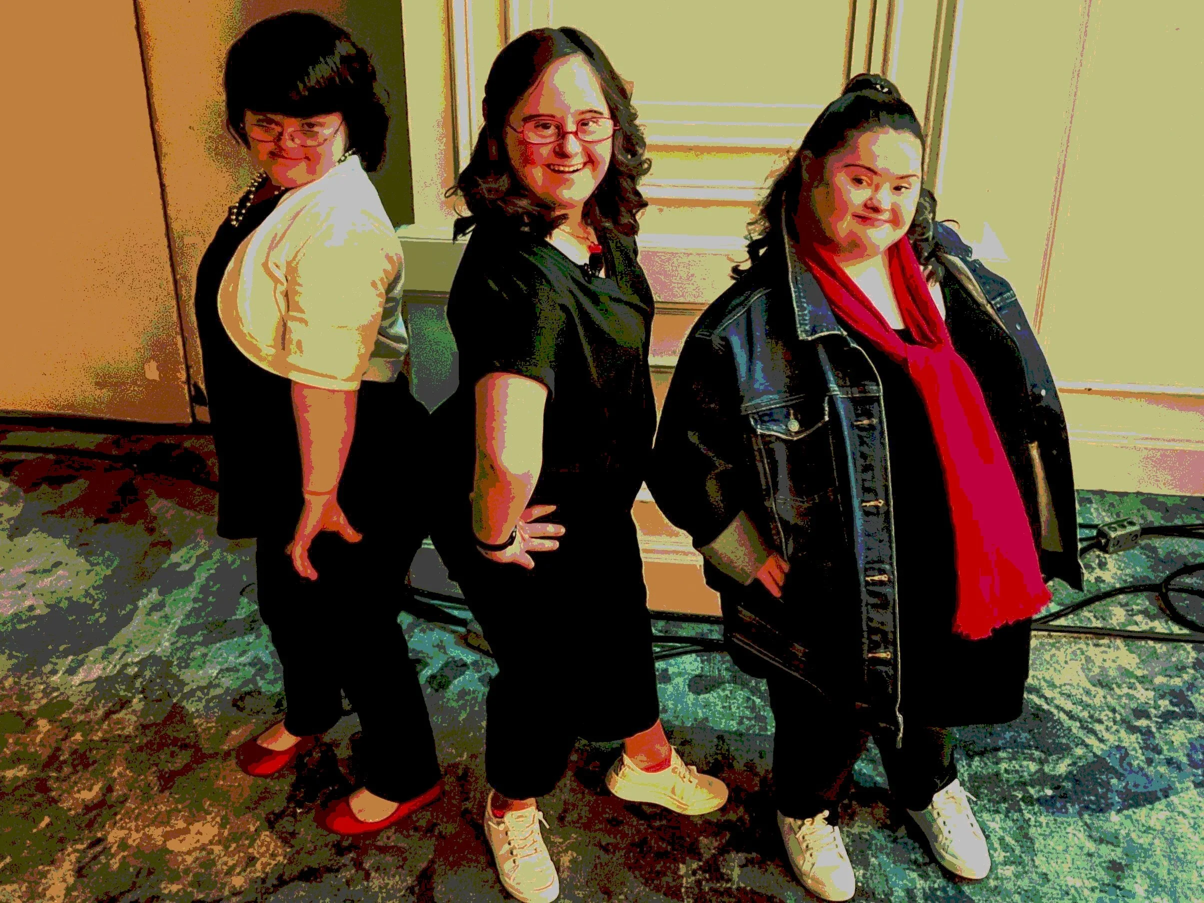 Three strong women with Down syndrome exhibiting advocacy.