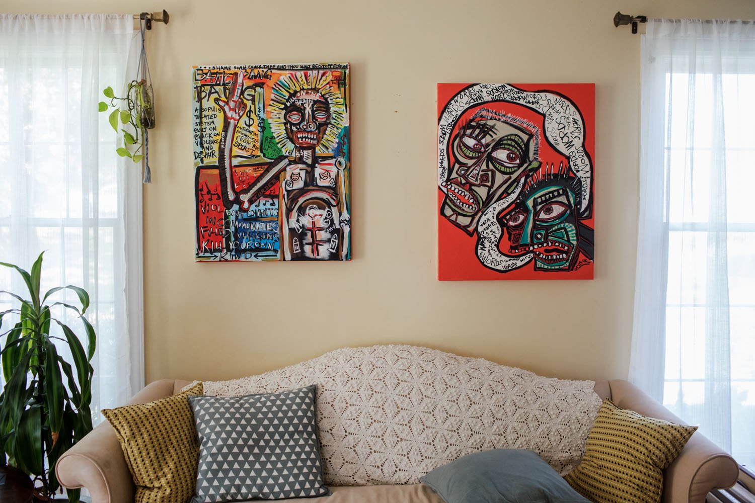 Jason Flack's paintings on display in the living room portion of the house gallery.