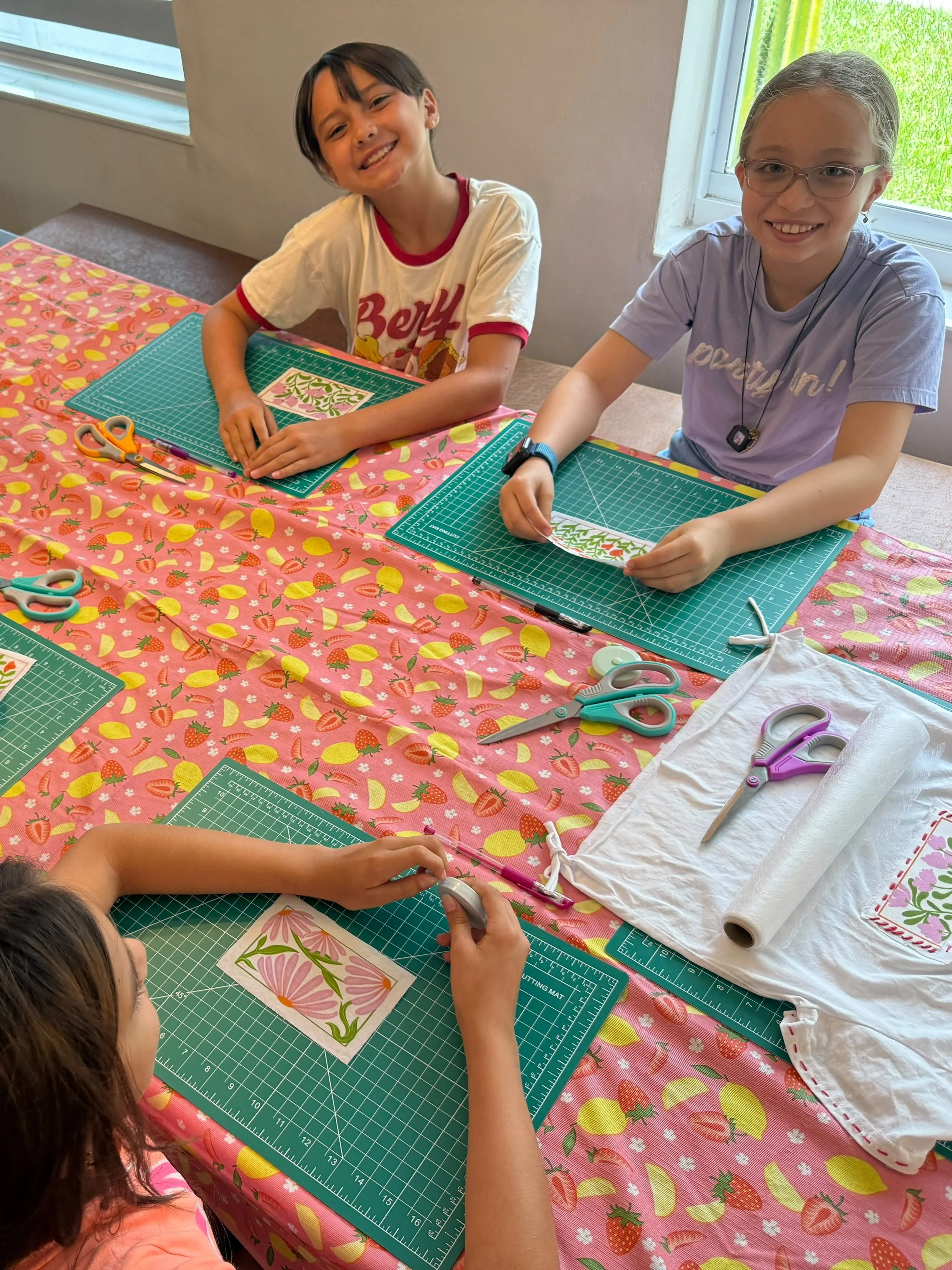 Group of Kids with patches and materials to embroider.