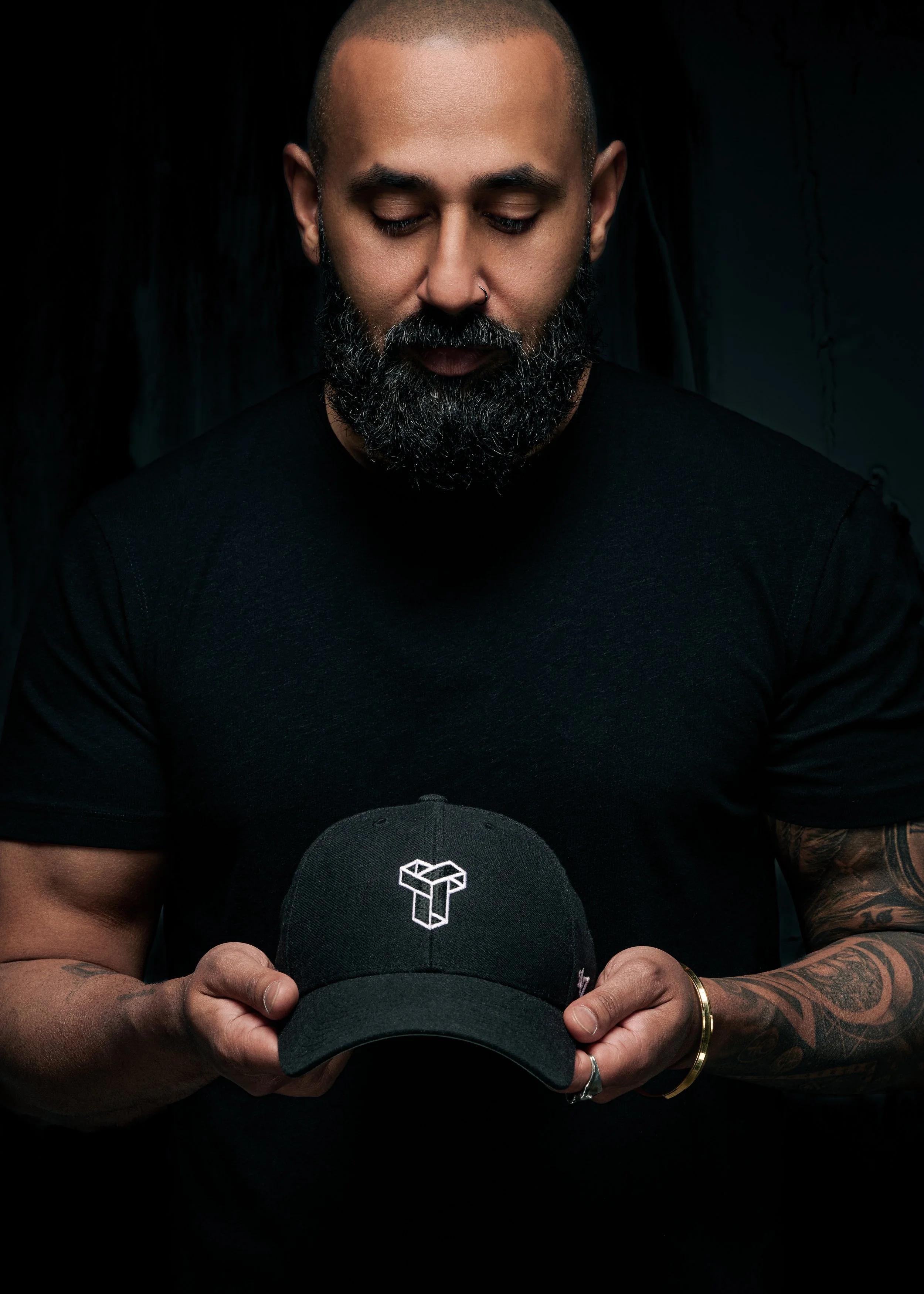 Neel Singh Holding Tropoly Hat