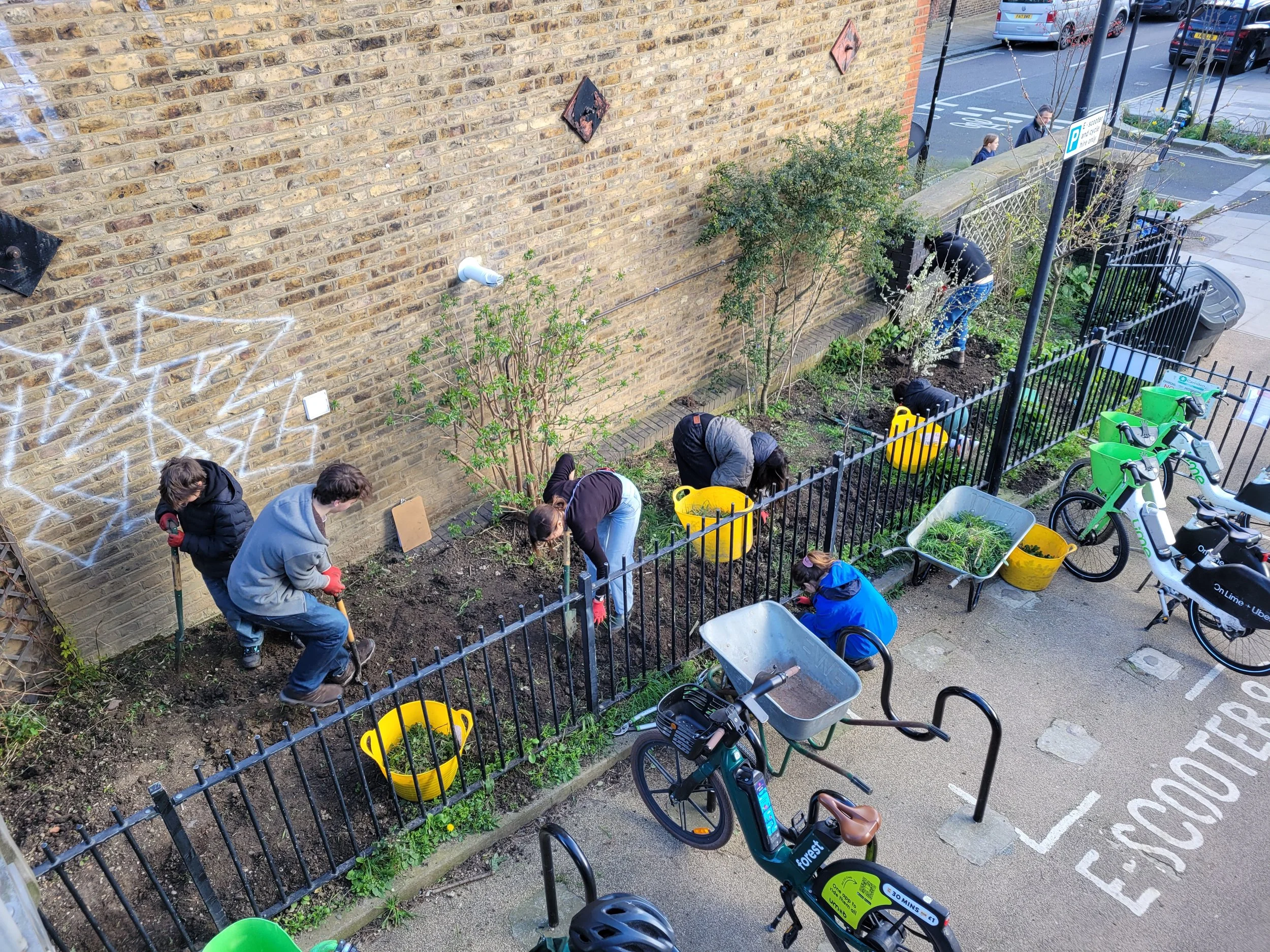 Youth volunteers planting a new orchard bed by Savernake Bridge