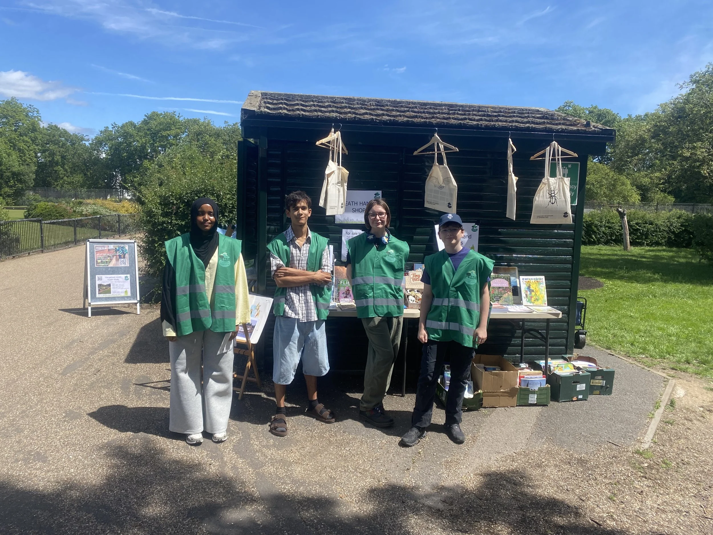 Youth volunteers standing outside the Heath Info Hut