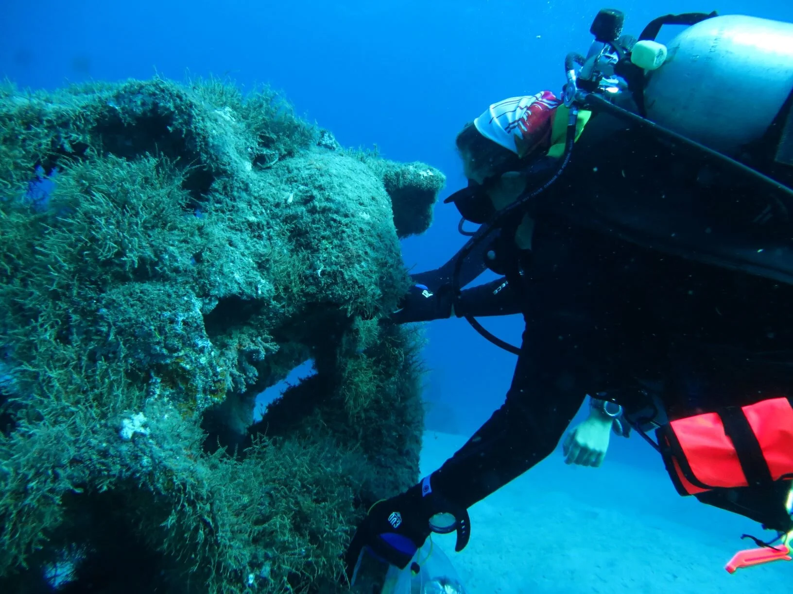 Scuba diver exploring coral reef underwater.