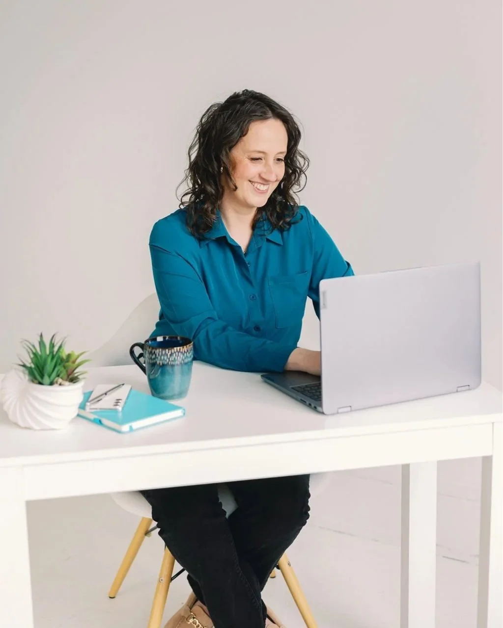 Annie Hanson reviewing a debt payoff plan at her desk