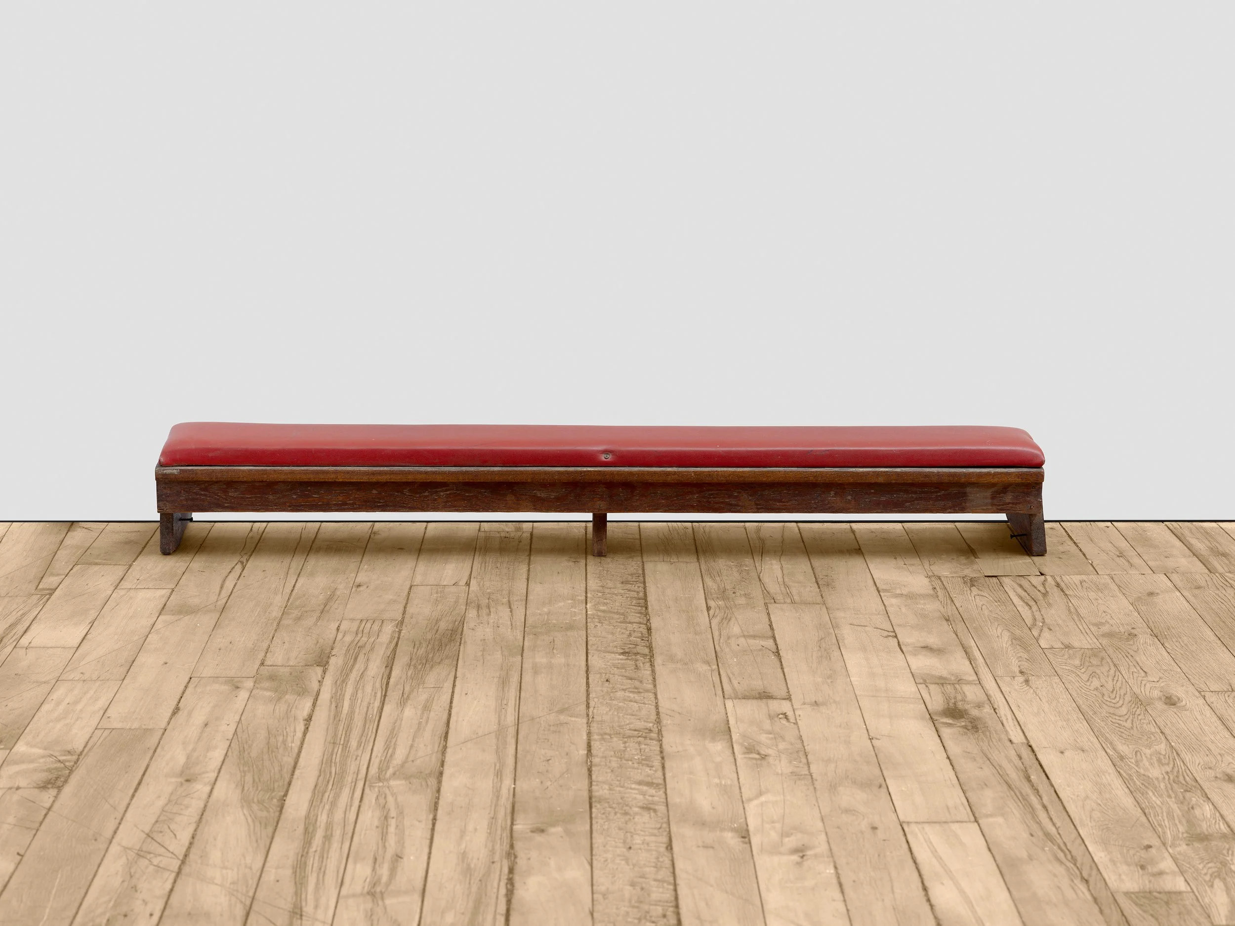 a rite of remembrance, 2025. 
Reclaimed pew kneeler. 
7 1/2 x 51 5/8 x 9 1/2 inches (19.1 x 131.1 x 24.1 cm).
