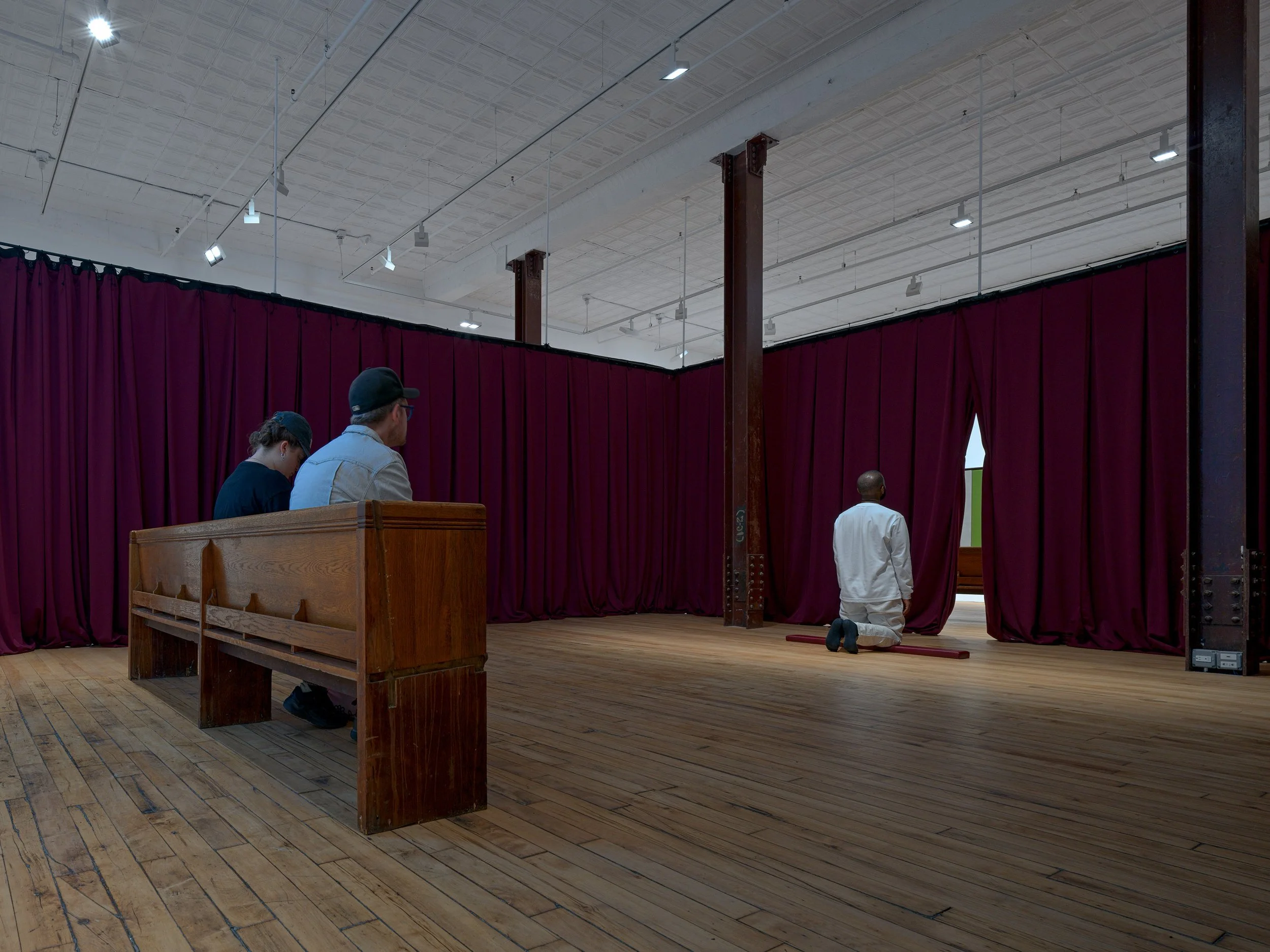 Yearning for an Absolute, 2025.
Pew kneeler pad, velvet curtains, and durational performance.
Photo: Kerry McFate.