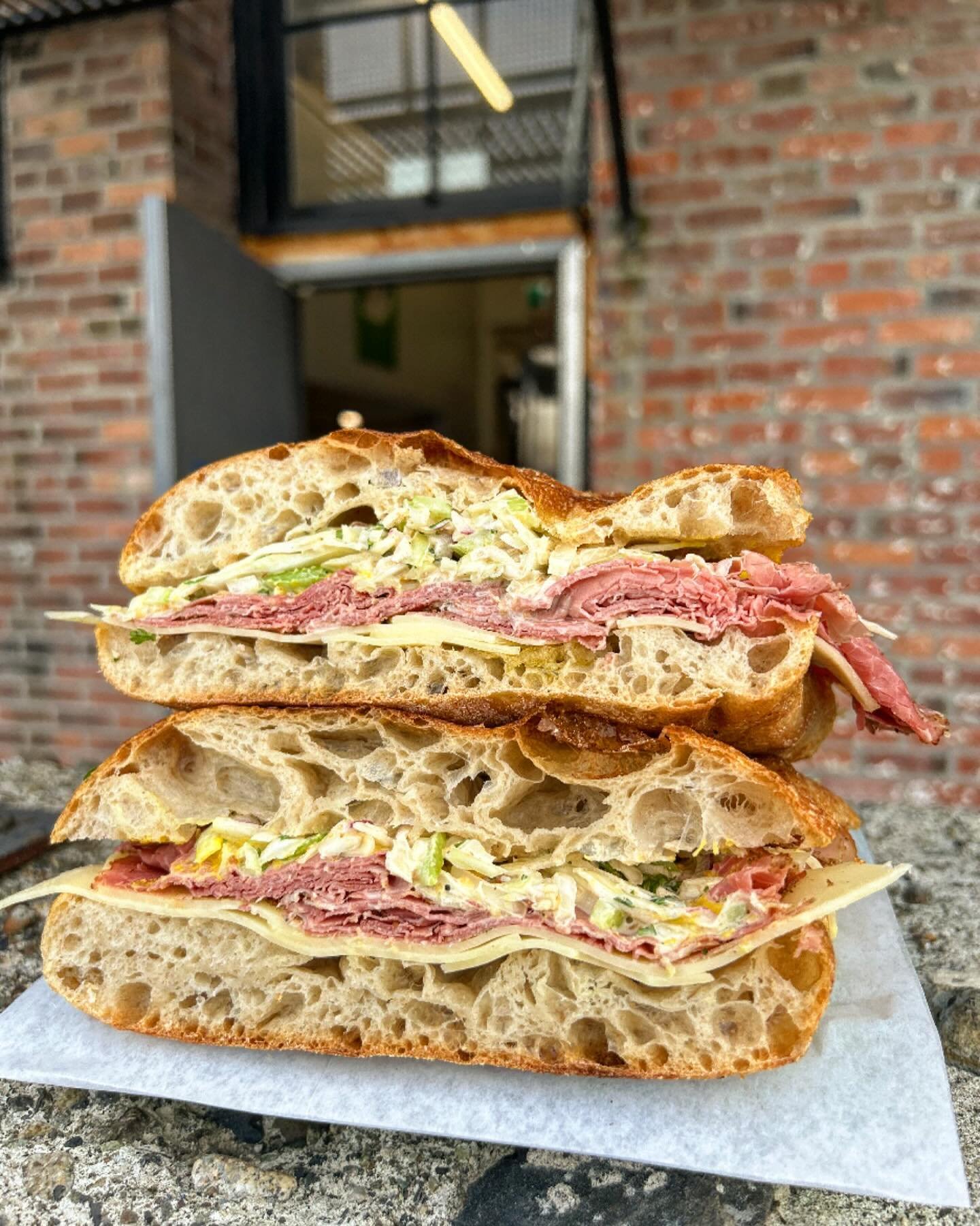 feels like a reuben - @fourquartersmeats smoked beef, yellow mustard, emmenthal, creamy-crunchy cabbage, celery, and red onion slaw with l&rsquo;il mac sauce. onna slab.