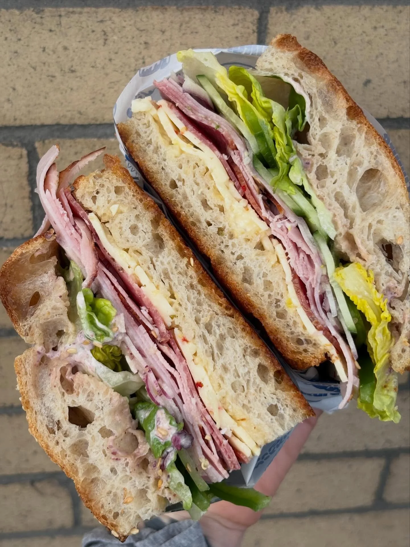 Sub Shop Combo on NOW!

smoked ham, salami, prosciutto cotto, lettuce, cucumber, crunchy green peps, pepperoncini mayo AND olive mayo, havarti, red onion

all on our sourdough focaccia made just this morning 🥵