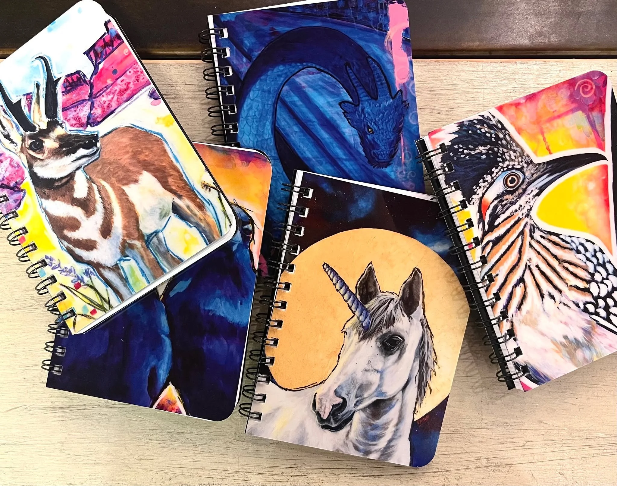 I restocked some little journals at @ghostwolf_gallery this week. I almost kept that dragon one for myself. haha 

There are also journals on my website, but those are a little larger.