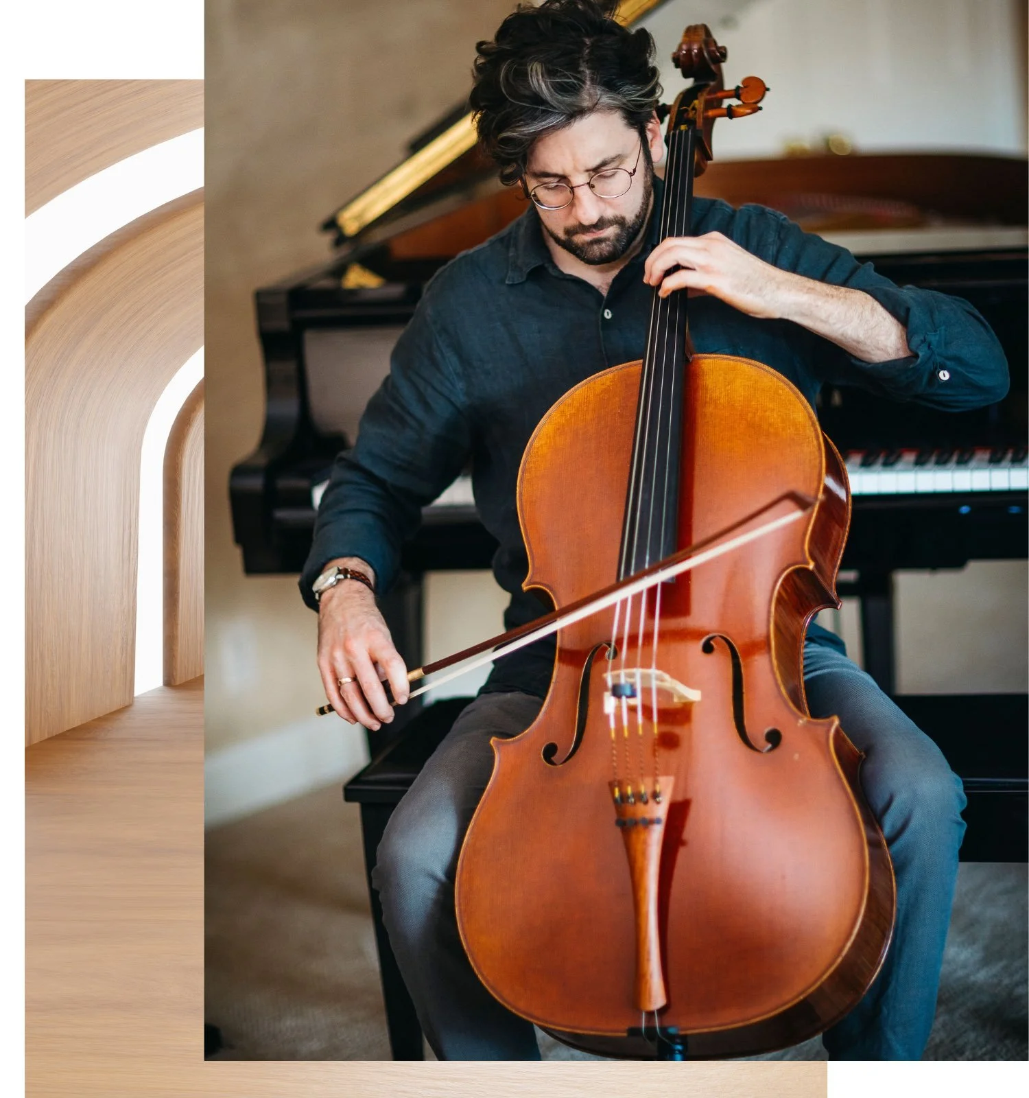 Man playing a cello in front of a piano.