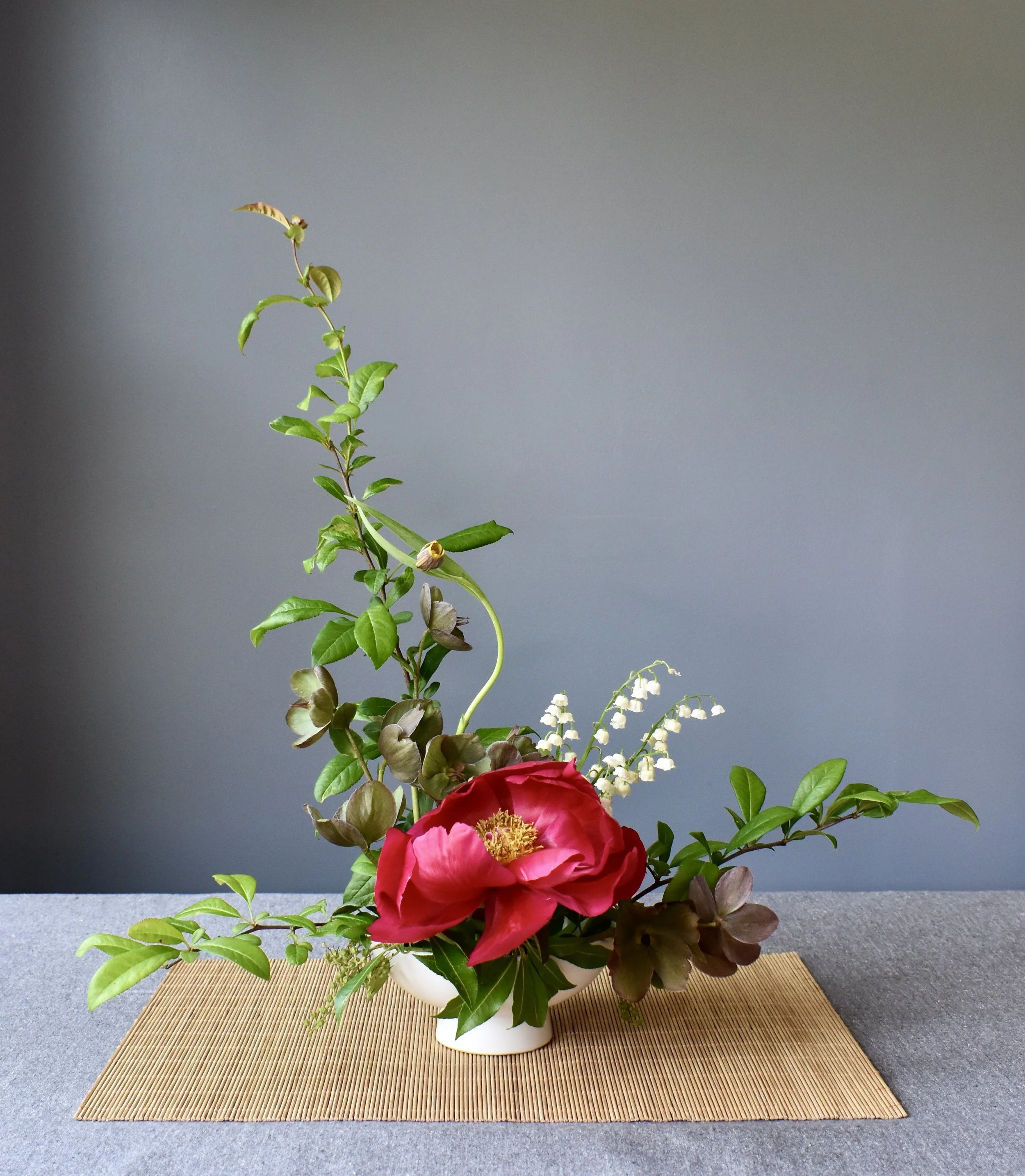 Ikebana style design with peonies and hellebores