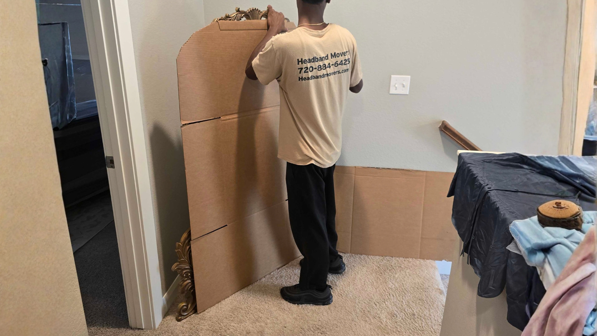Headband Movers crew carrying furniture during an apartment move in Wheat Ridge, CO.