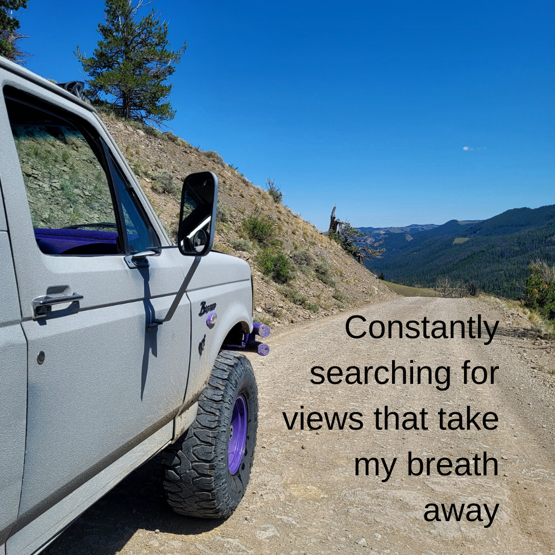 Off-road vehicle on a mountain trail with scenic views, accompanied by the text "Constantly searching for views that take my breath away."