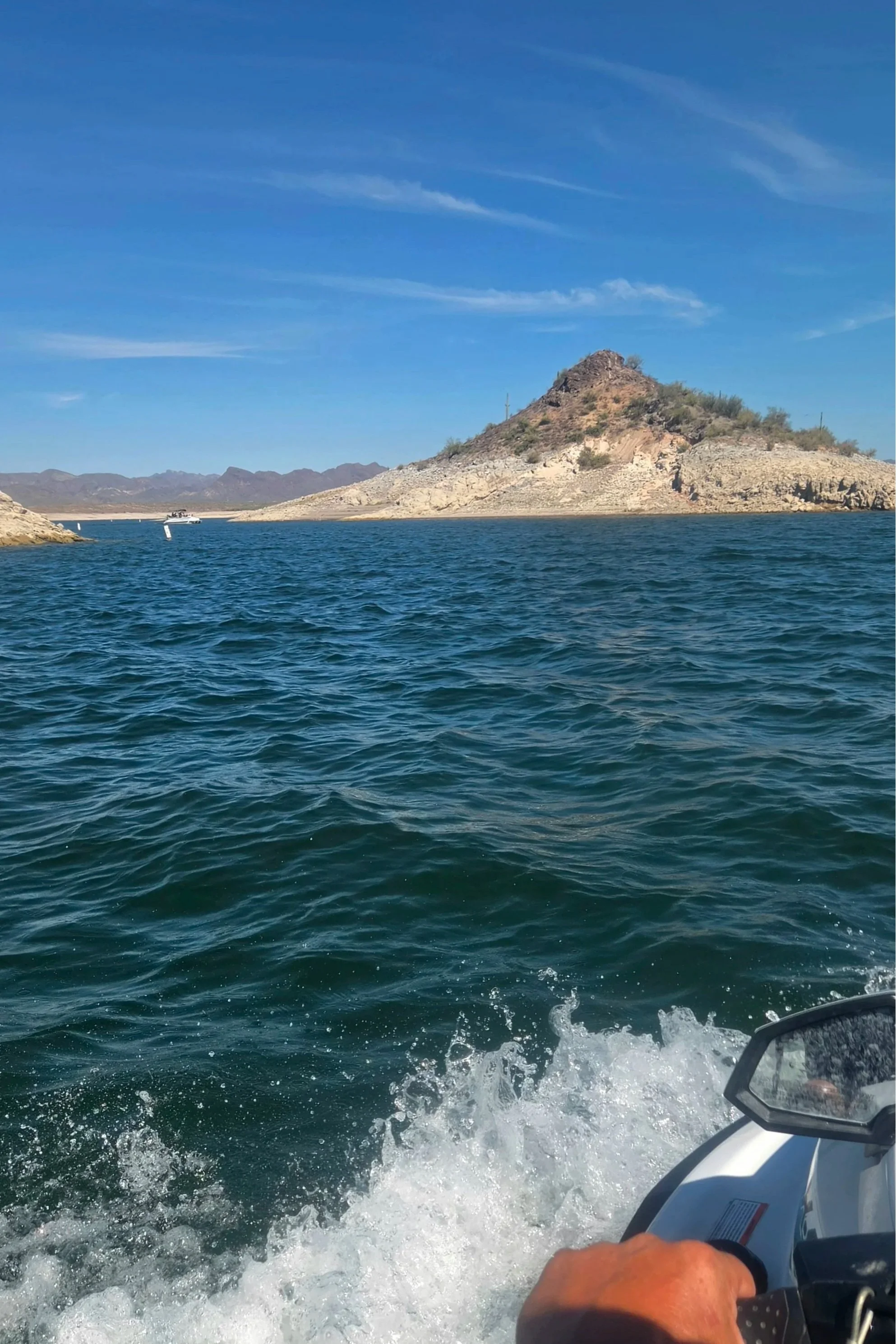 Boat and jet ski on lake