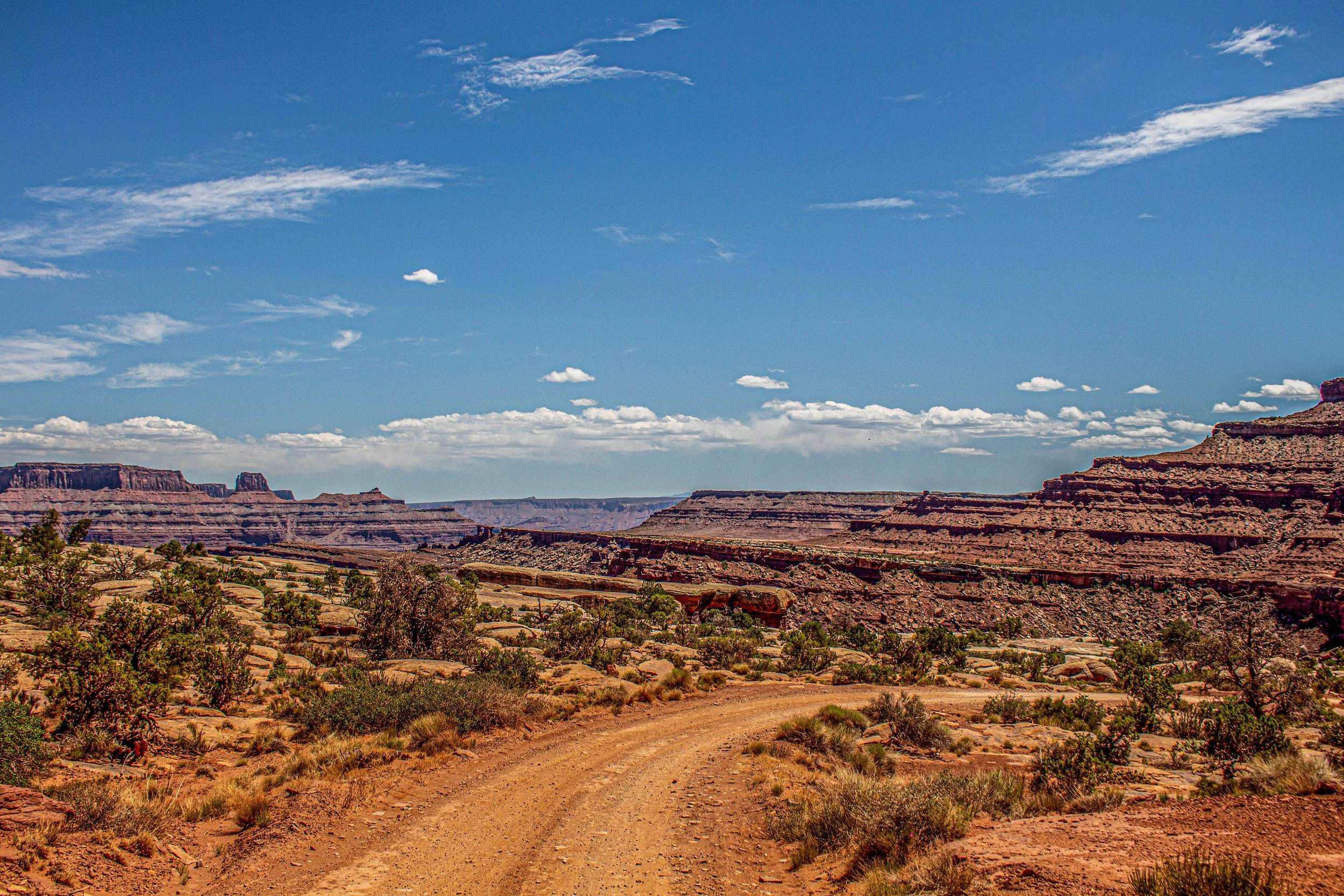 Dirt road with mountains surrounding in Moab, Utah
