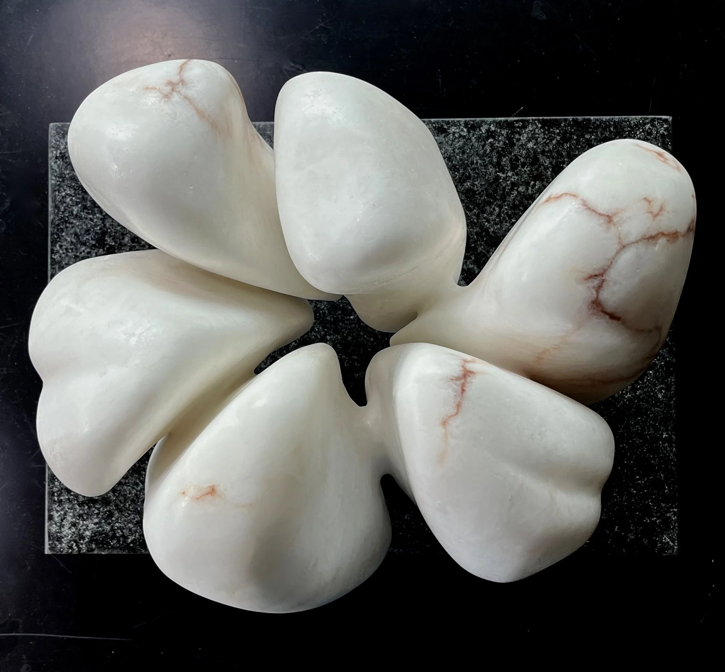6 Winds - alabaster sculpture on a polished granite base 40cm across base