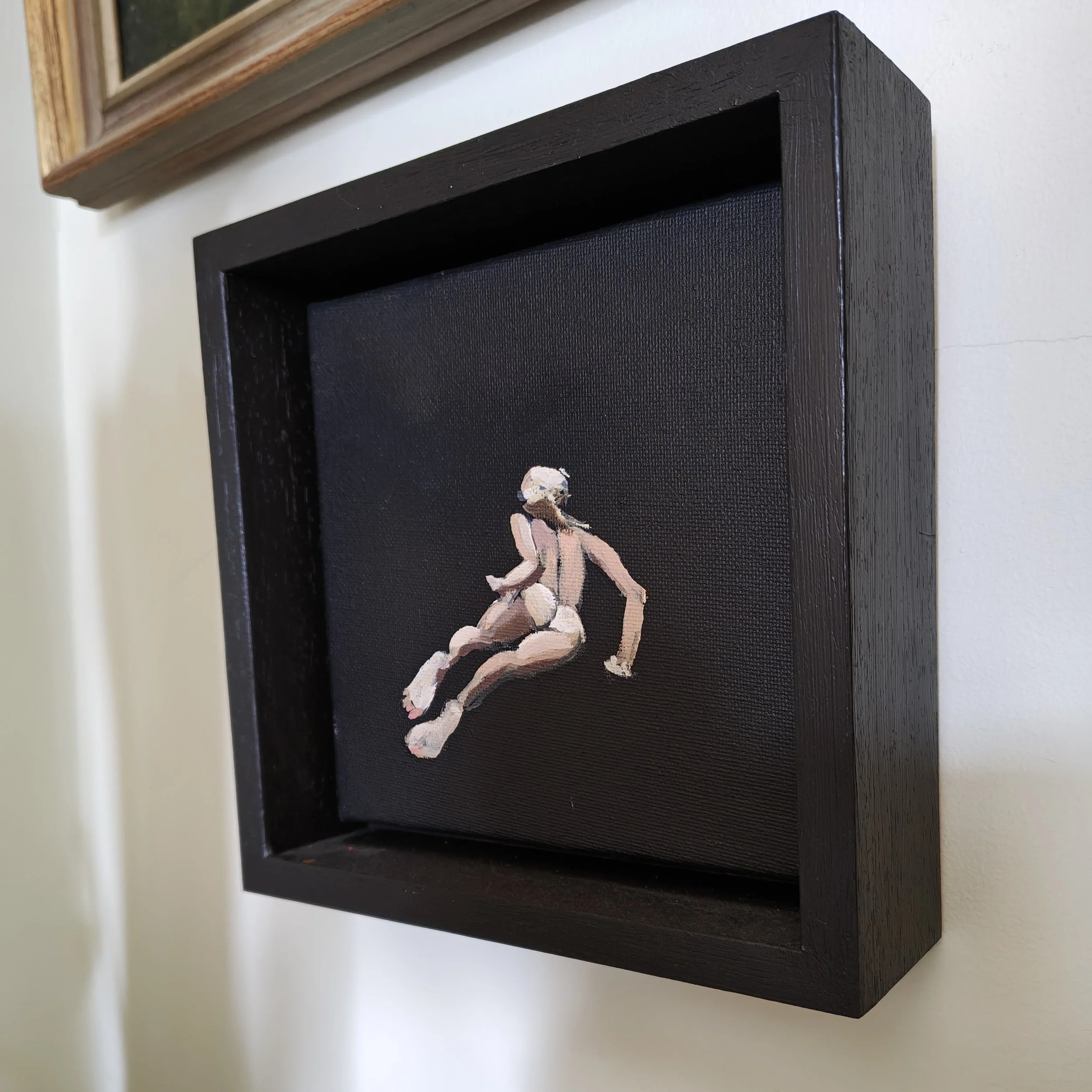 Canvas mounted in a black tray frame