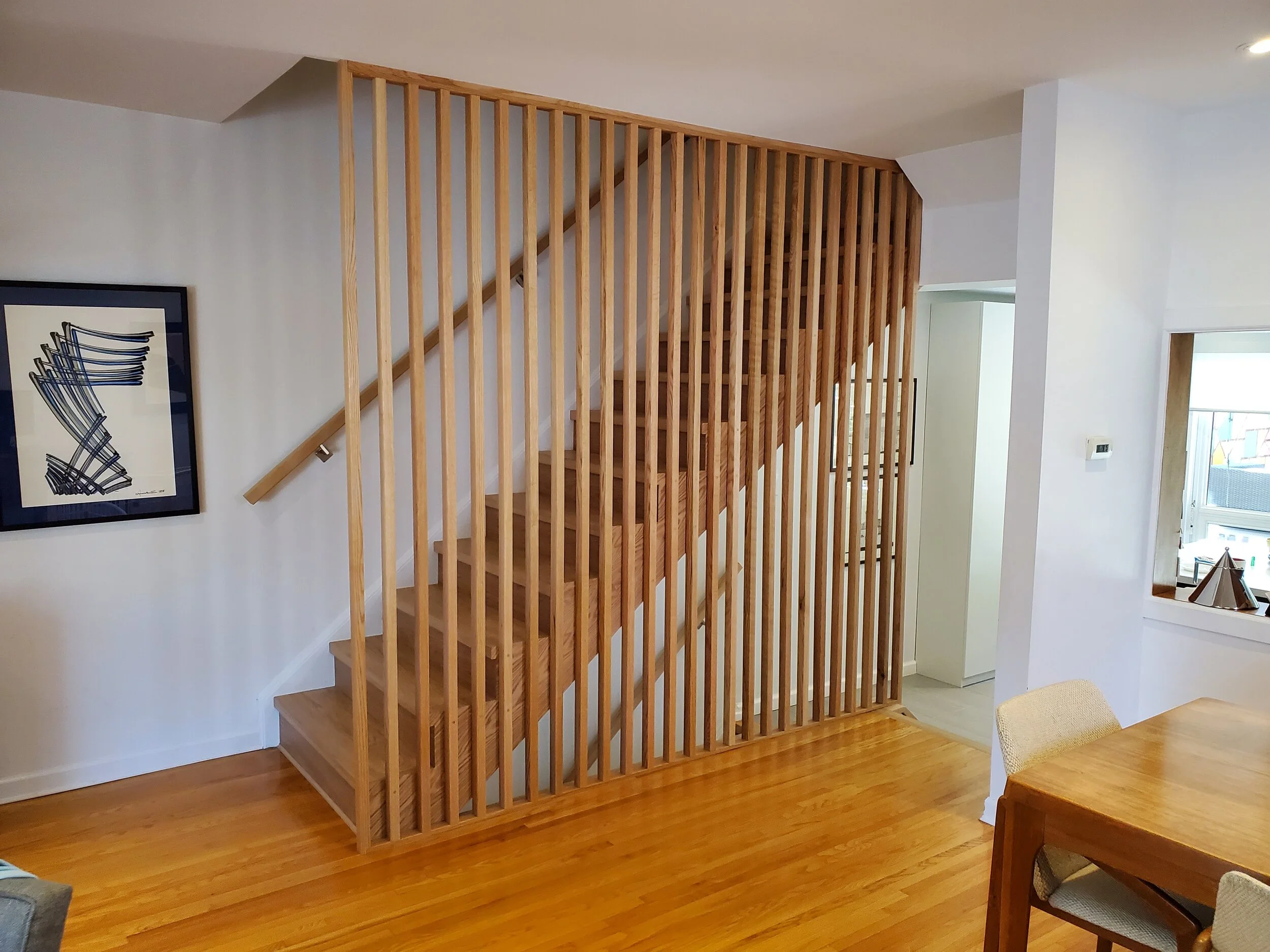 Custom mid-century inspired stair screen our of red oak to replace an old railing. 