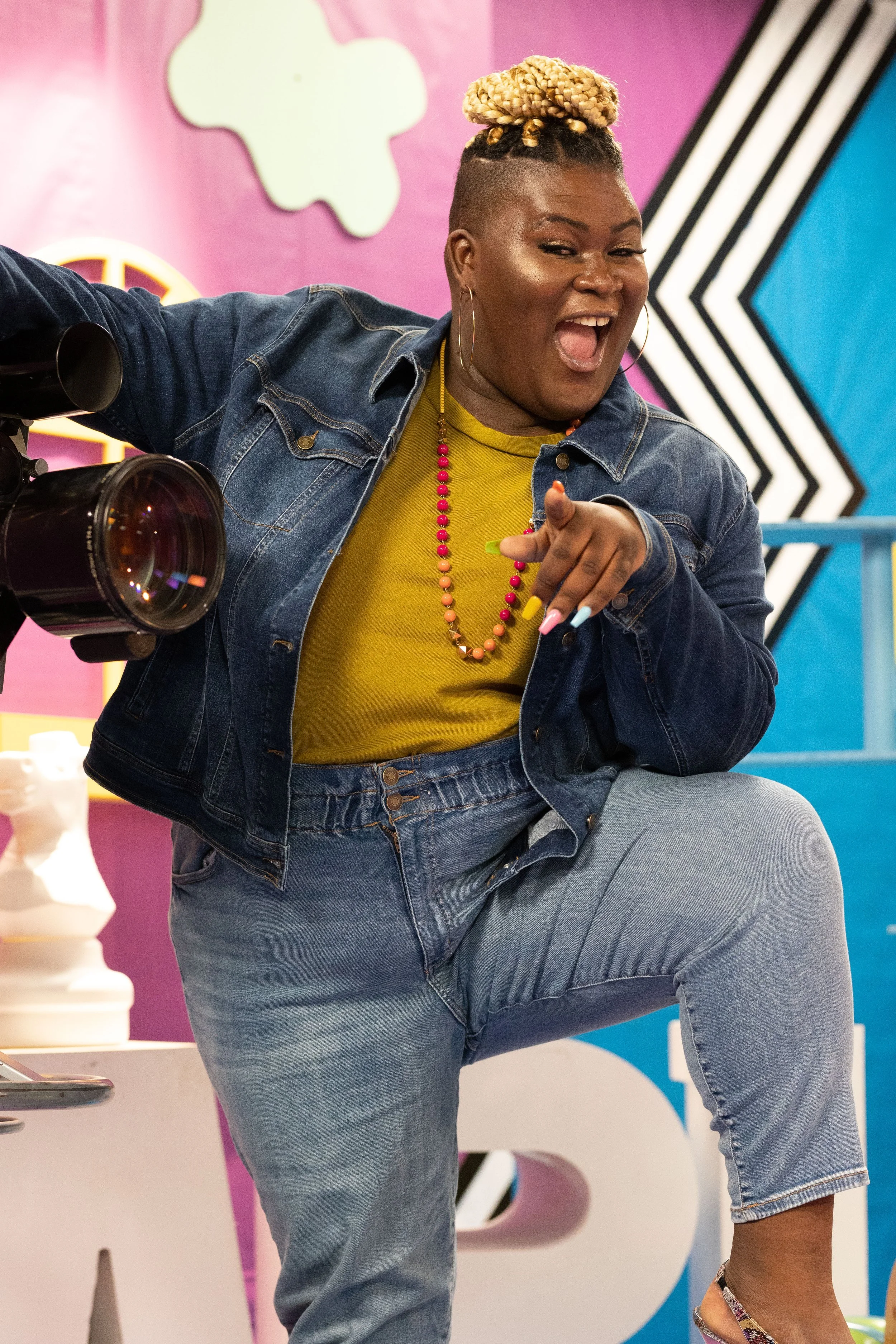 Modern fresh, dewy, and highlighted skin with a gold glitter eye, false lashes, and  glossed natural lip.