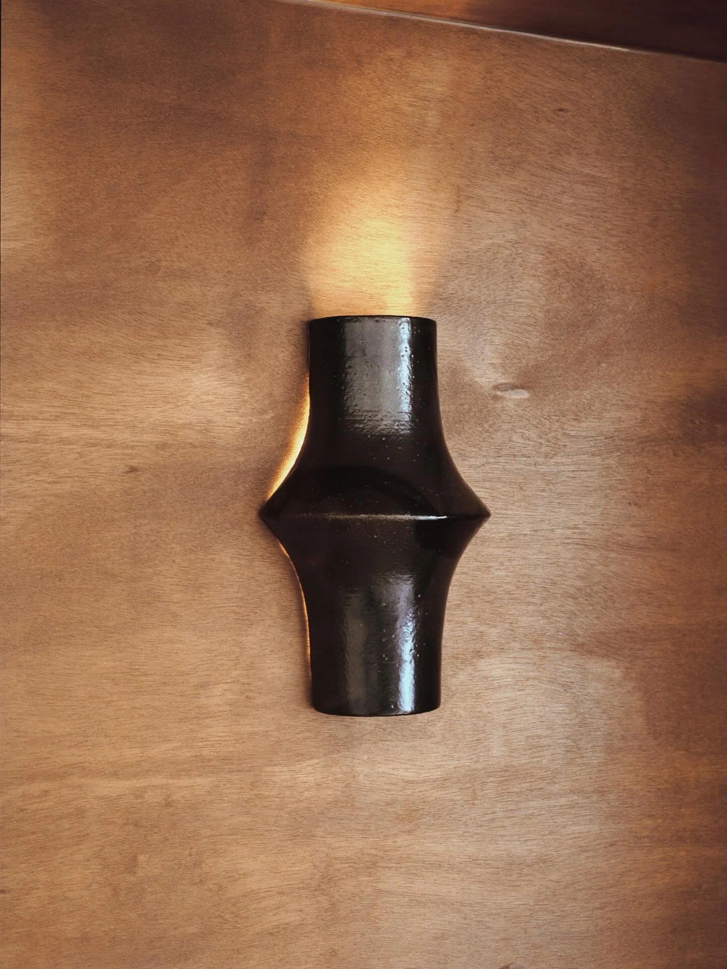 details of the store 

rich wood tones and glazed ceramic contrasting with the brushed steel racks and concrete floor ; a draped curtain acting as background and continuing into a fitting room ; vintage furniture spanning 1930s - 1960s 

Em Archives

