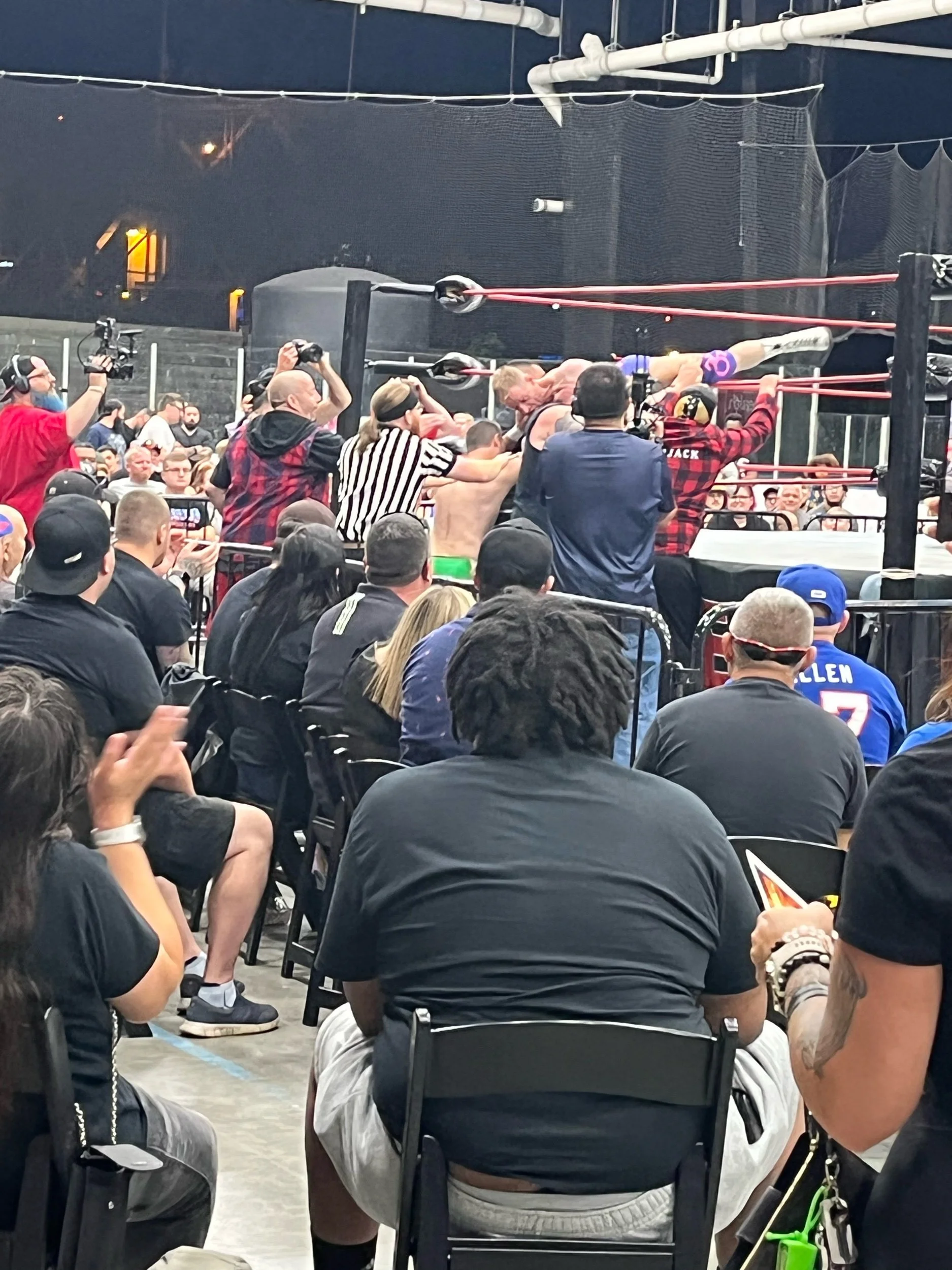 The ESW alumni lumberjacks forcibly carry Gregory Iron back to the ring after Iron tried to escape his match with Vinnie Moon