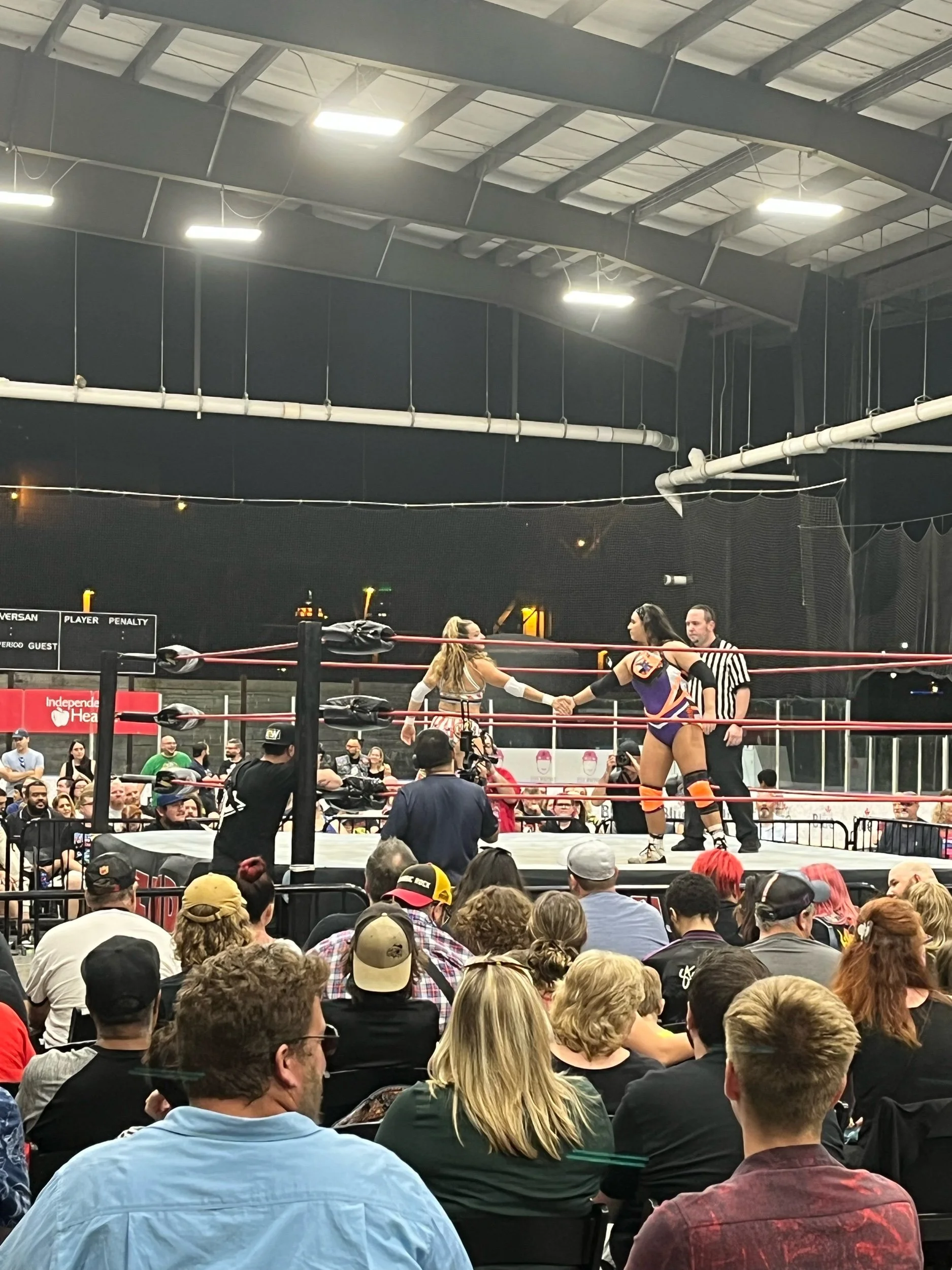 Christina Marie and Rachael Ellering with a show of sportsmanship and mutual respect before their bout