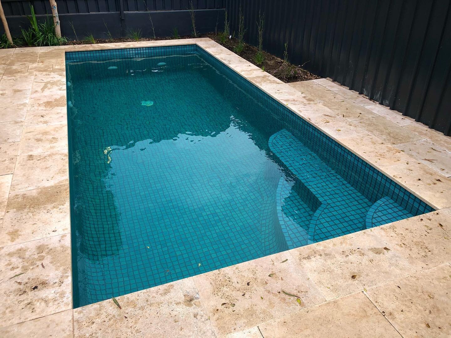 Recently finished 2.5x6.0 plunge pool looking sharp with travertine and island sea mosaics #plungepool #mosaics #travertine #poolbuilders #concretepool