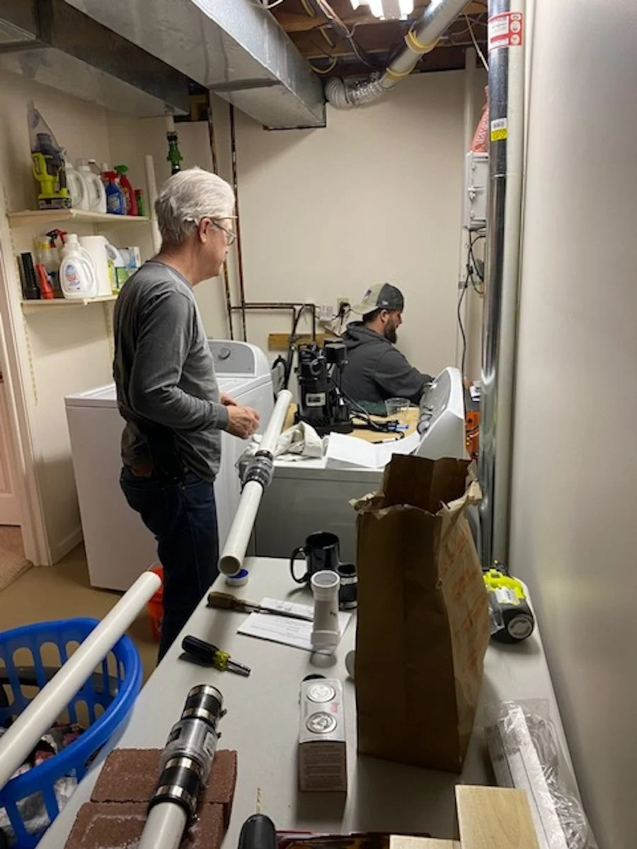 John and Jesse installing two tiered sump pumps.