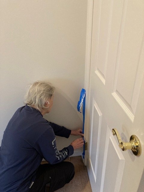  About a year after moving in we got to updating the guest bedroom starting with repainting the walls after Jesse had done a little touching up of some cracks in the drywall. We pulled out the carpet and Pam painted the walls.
