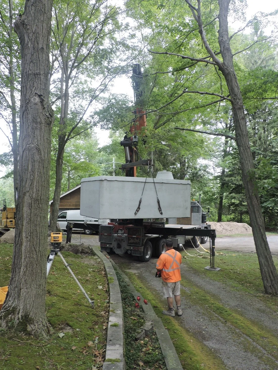 Then a truck with a crane very carefully lifted the cistern up off the truck and navigated it through the trees and power-lines.