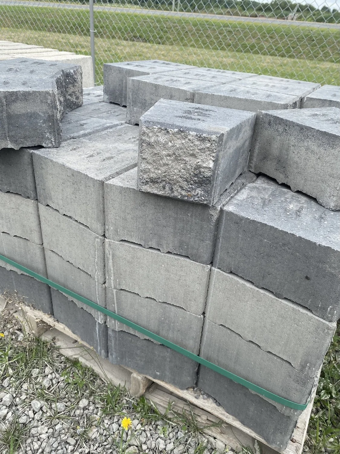 Then we moved a lot of sand to cover the end of the cistern on the firelane side that stuck up above the slope of the hill and had pallet full of blocks delivered to build a retaining wall to enclose the cistern. 