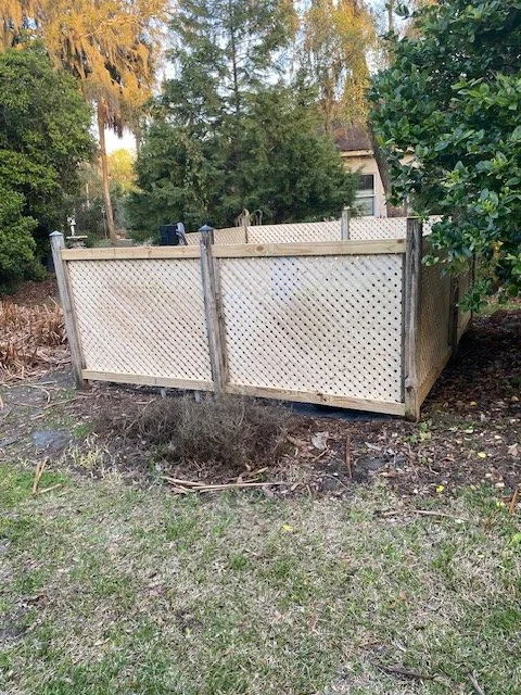 This is the new lattice fence around the well pump and trash can storage area.