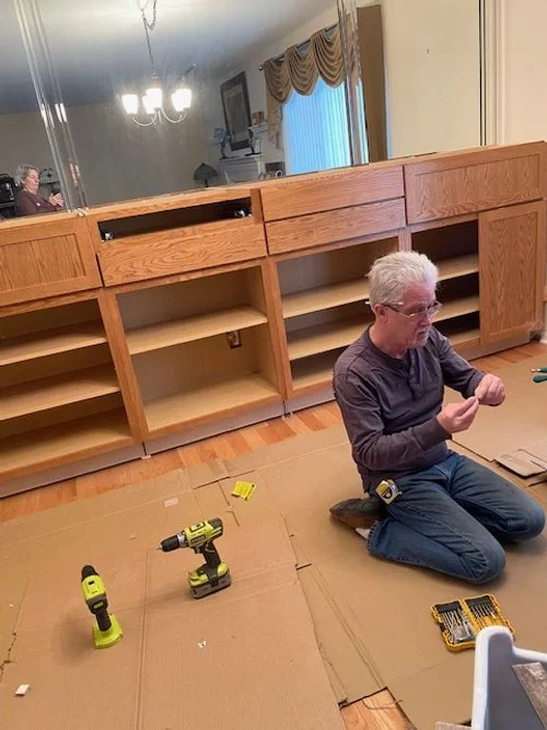 Drawers being mounted on base cabinets.