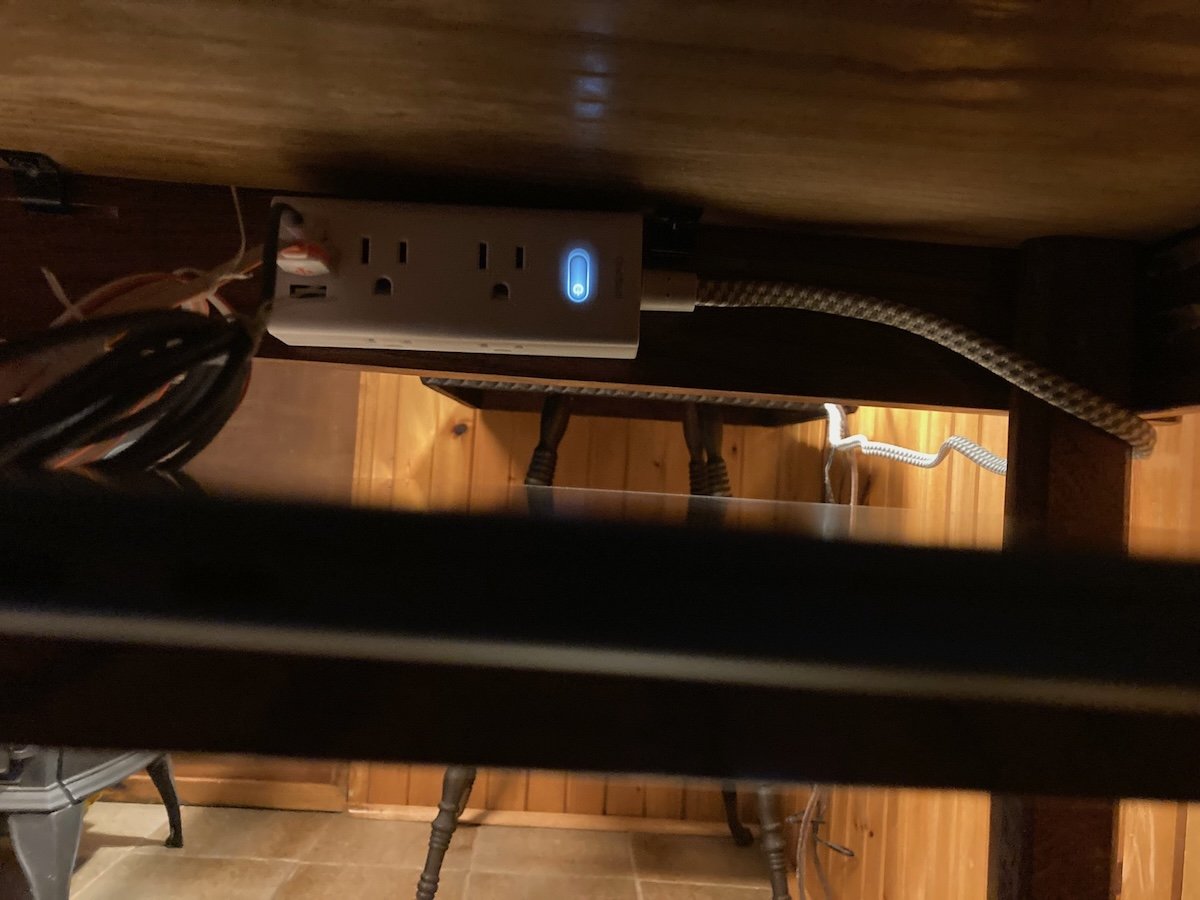 The concealed power block for charging electronics on the recycled wood table.