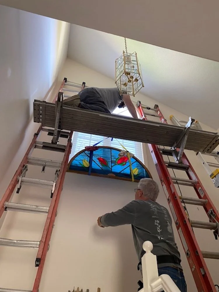 Here I am on the first landing passing the window up to Jesse. It was in a simple sling we could easily remove when we got the window to the platform.