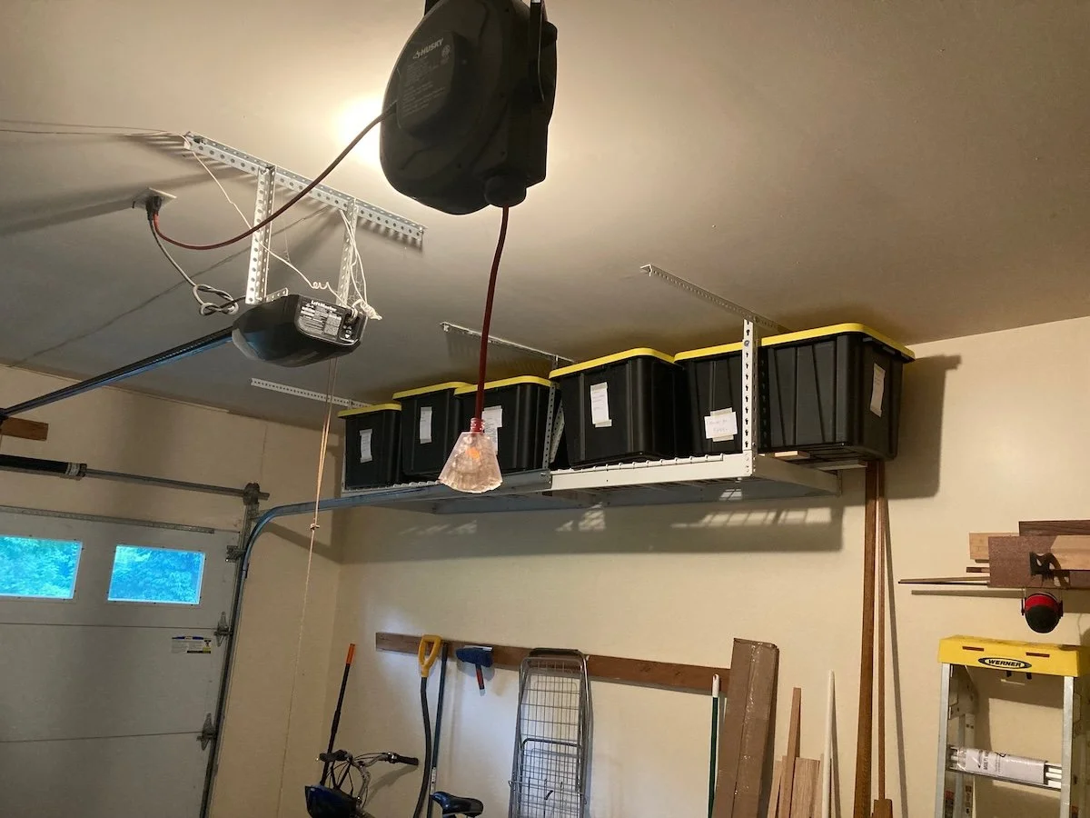 We added extra storage near the ceiling and a retractable power cord to make woodworking etc. easier. Luckily Jesse is not far away and has a great collection of contractor tools that I have already borrowed several times.