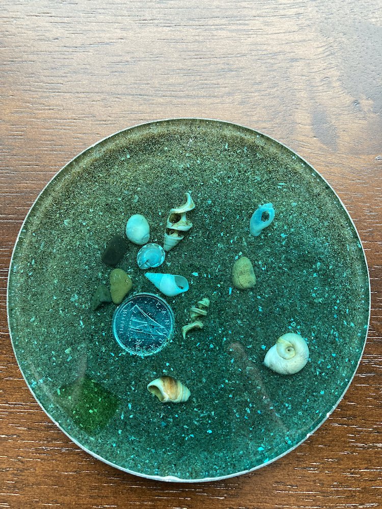 Resin beach coaster with beach glass shells and a Canadian dime sailboat up (1 of 6)