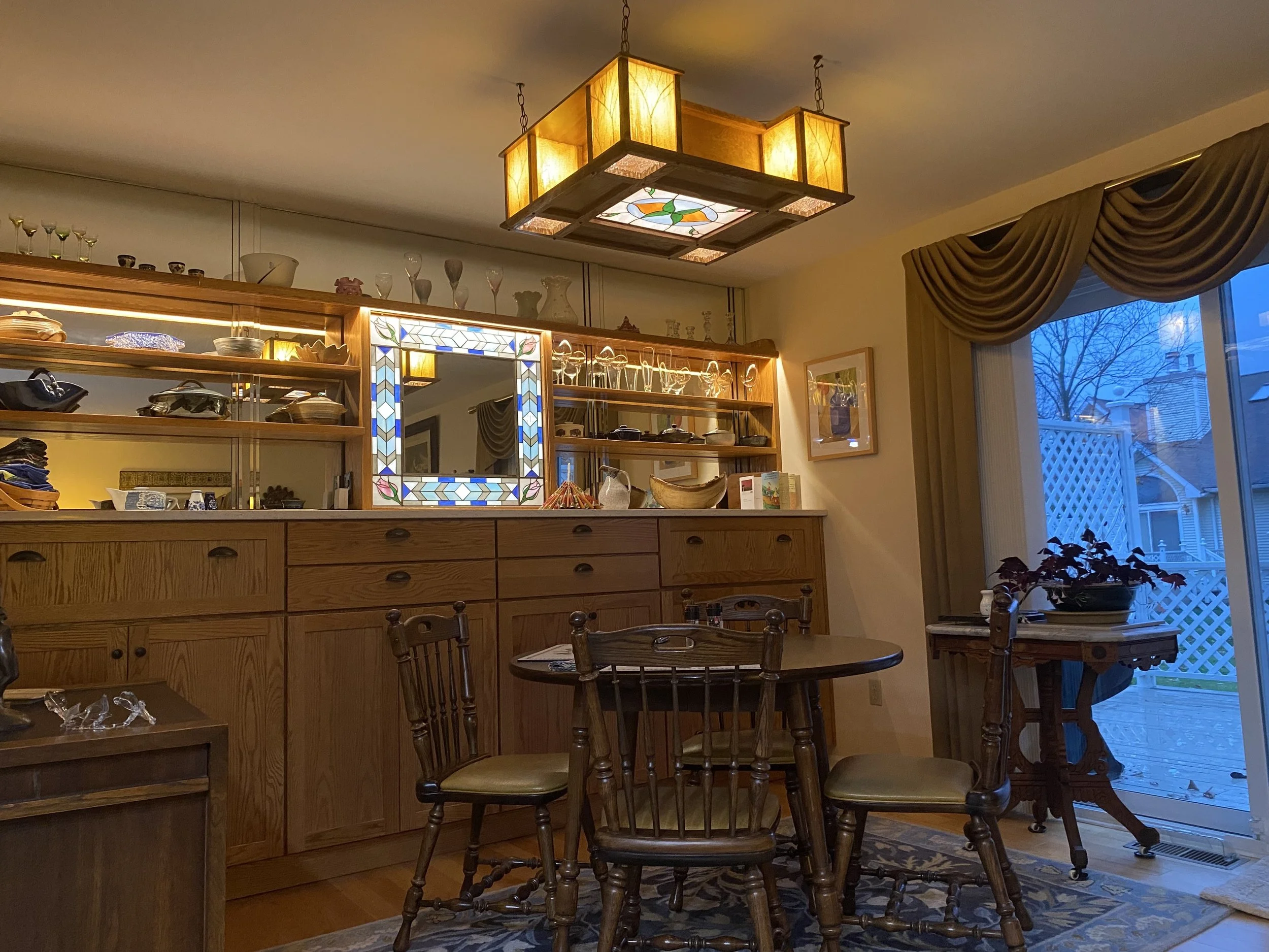 The dining room chandelier was an involved project with the woodwork done at the lake over the summer,  the stained glass done at the townhouse in the fall and the electrical and installation finally done in time for Thanksgiving. More on the constru